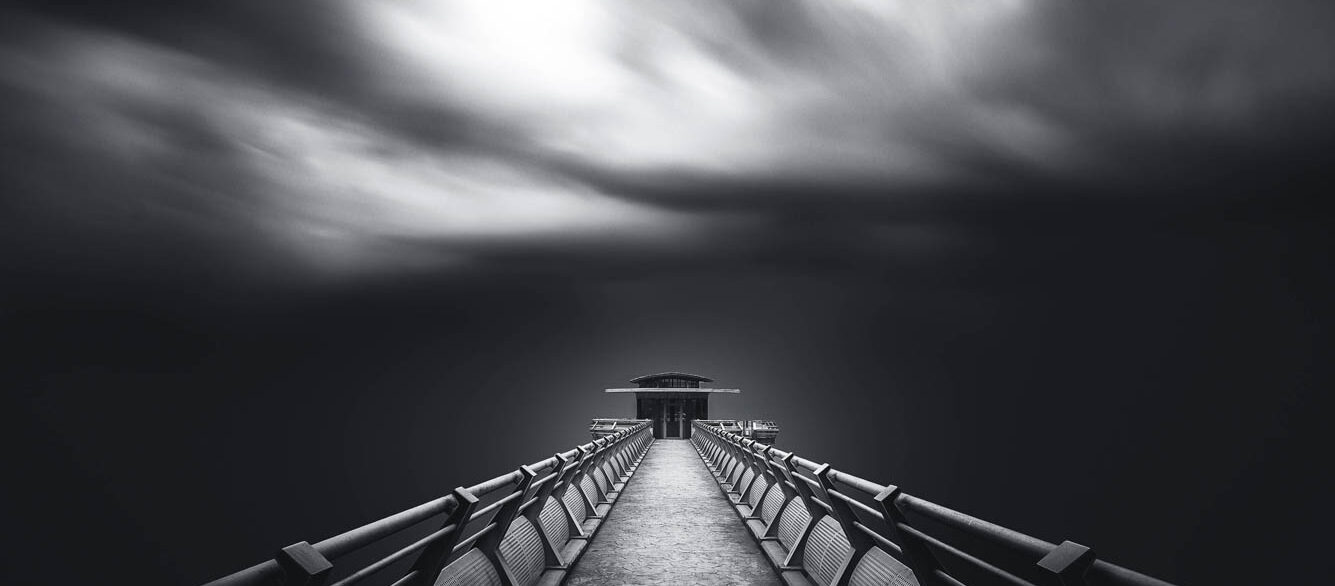 Perspective of road towards a tower with cloud moving blown by strong wind. Perspective of road towards a tower with cloud moving blown by strong wind.