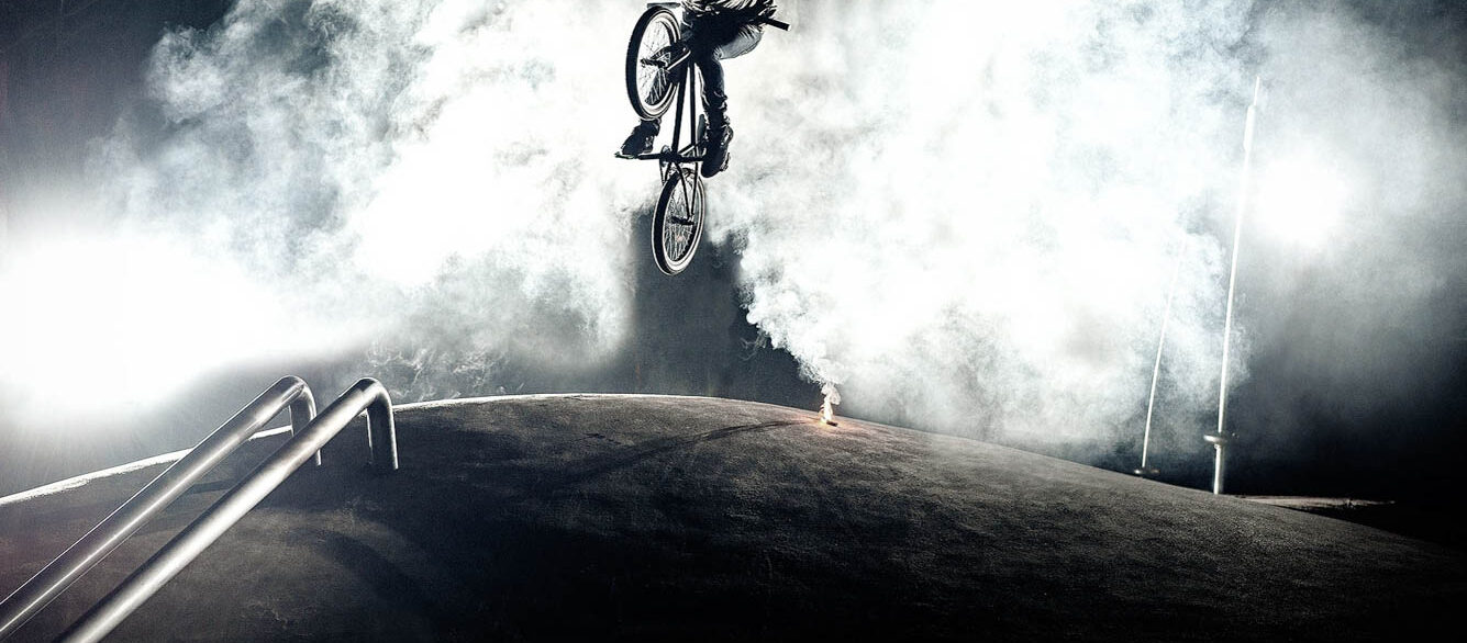 Low Angle View Of Young Man In Mid-Air With Bicycle Low Angle View Of Young Man In Mid-Air With Bicycle