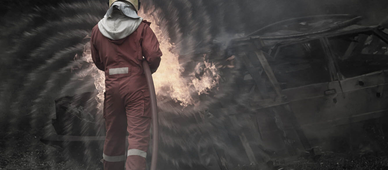 Firefighters who have been trained professionally are on duty to control the fire from various accidents and rescue the victims. Rear view of firefighter using hose on fire