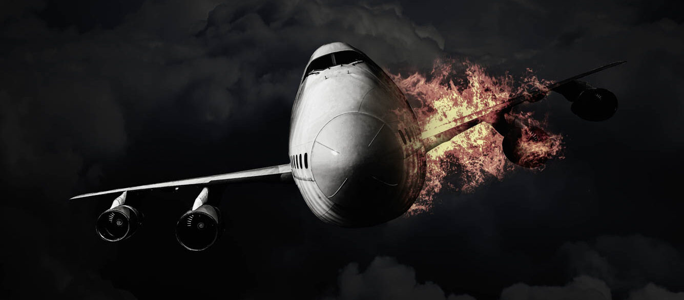 The passenger plane with engine on fire while flying in the sky Passenger airplane on fire