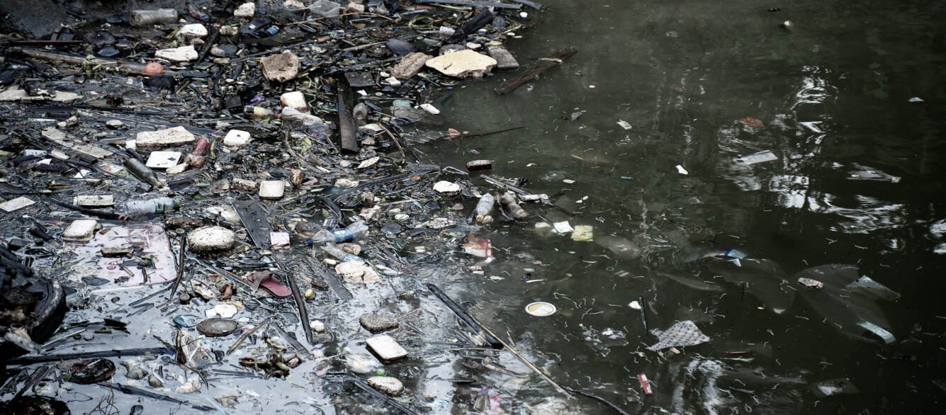 Plastic bottles and other trash on river Plastic bottles and other trash on river