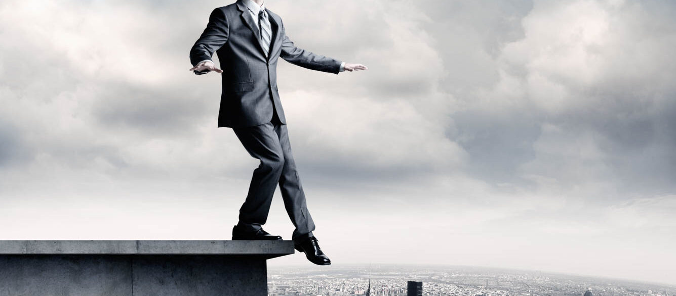 Blindfolded Businessman On Ledge Blindfolded Businessman On Ledge