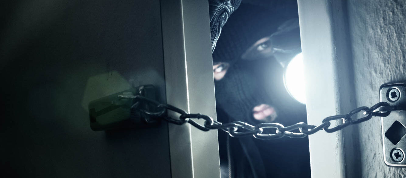 Burglar With Flashlight Seen Through Door Burglar With Flashlight Seen Through Door