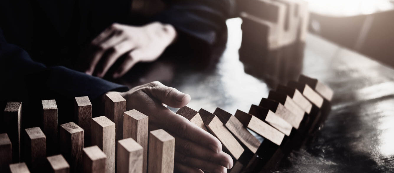 Business risk control concept, Businessman protect wooden block fall to planning and strategy in risk to business Alternative and prevent. Investment Insurance Business. Business risk control concept, Businessman protect wooden block fall to planning and strategy in risk to business Alternative and prevent. Investment Insurance Business.