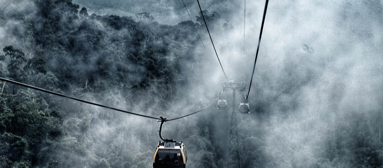 Cable car go to top of hill in the mist Cable car go to top of hill in the mist