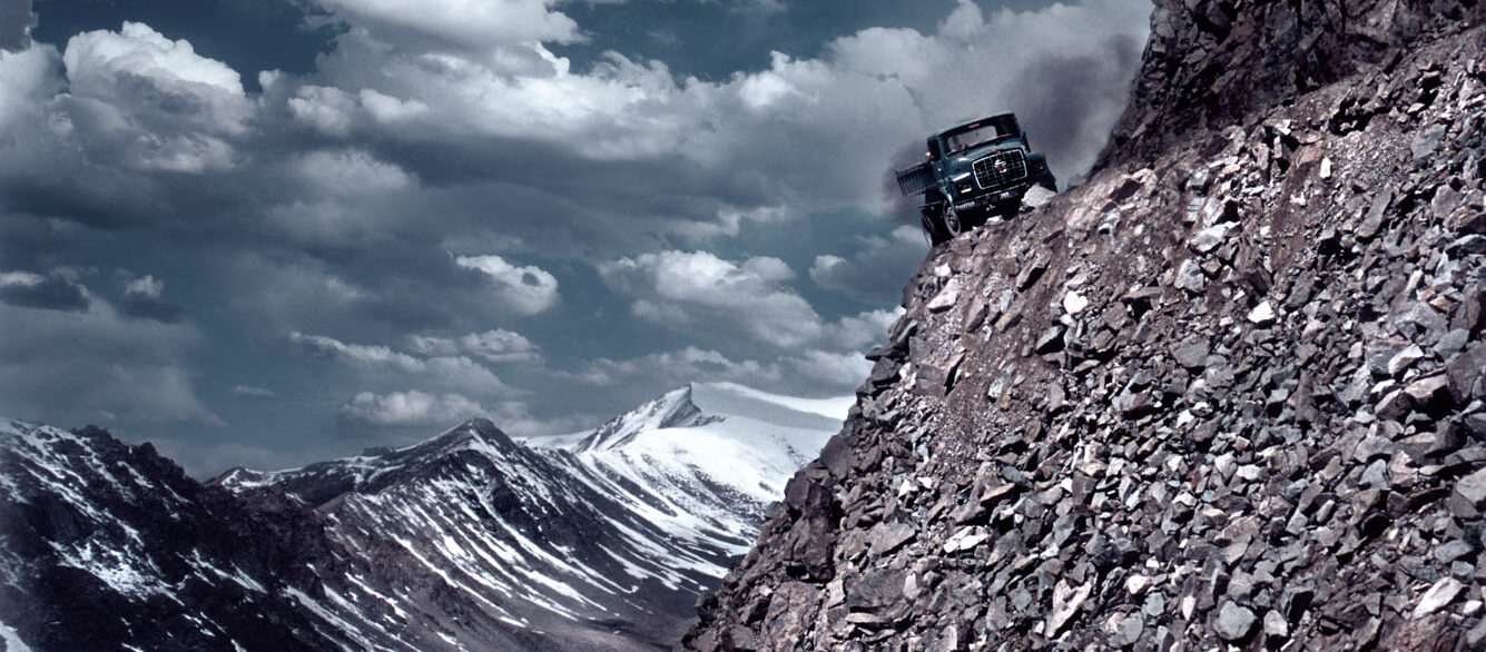 Truck dangerously close to edge of mountain road Truck dangerously close to edge of mountain road