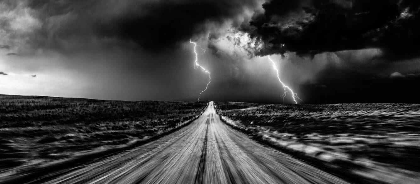 High speed storm chasing, taken from the roof of a moving car off road with double lightning bolts ahead. Colorado, USA. High speed storm chasing, taken from the roof of a moving car off road with double lightning bolts ahead. Colorado, USA.