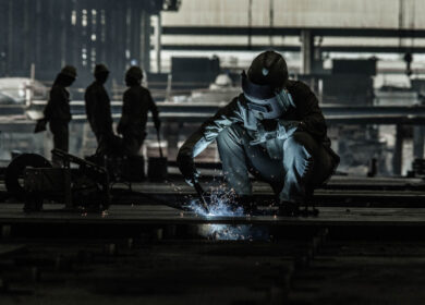 Welder working at a ship building yard in China.