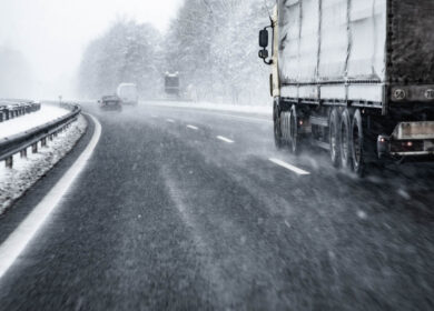 Truck Driving on Wet and Slippery Highway in Winter